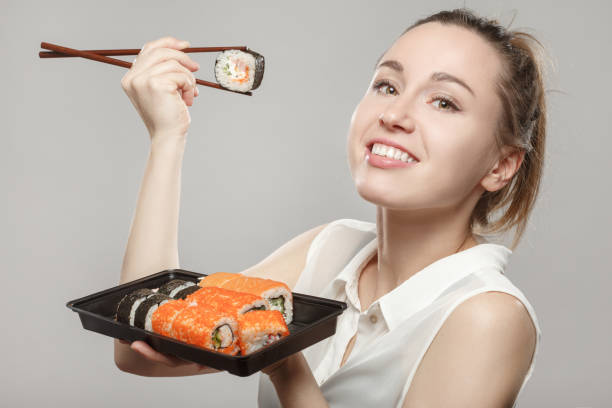 istock woman with sushi 1402859808