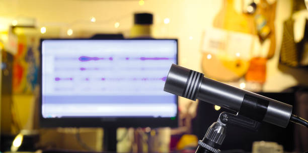 istock Podcasting concept, vintage recording microphone and messy workplace on blurred background 1402861008
