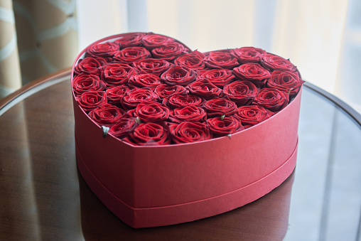 Valentine's Day Gift with Red Roses and envelope on a Dark Wood Background