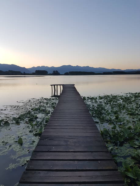istock Walkway on Lake candia at sunset. 1402863767