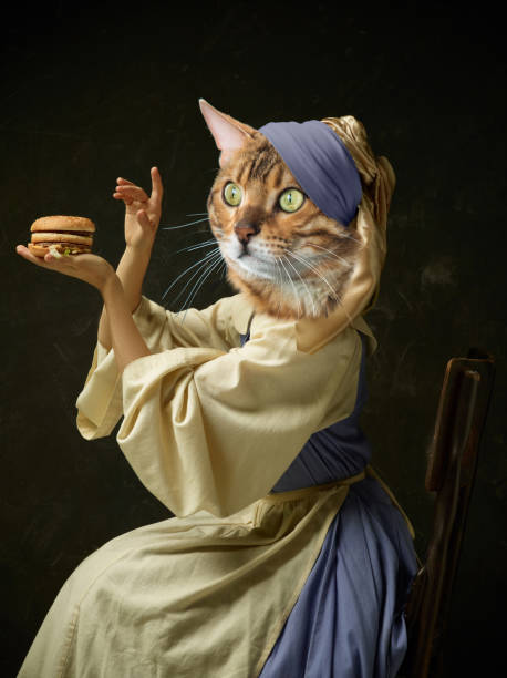 Graceful female model like medieval person in vintage clothing headed by cat head isolated on dark retro background. Comparison of eras, artwork Tasting burger. Graceful female model like medieval person in vintage clothing headed by cat head isolated on dark background. Comparison of eras, artwork, renaissance style. Contemporary collage. prince royal person photos stock pictures, royalty-free photos & images
