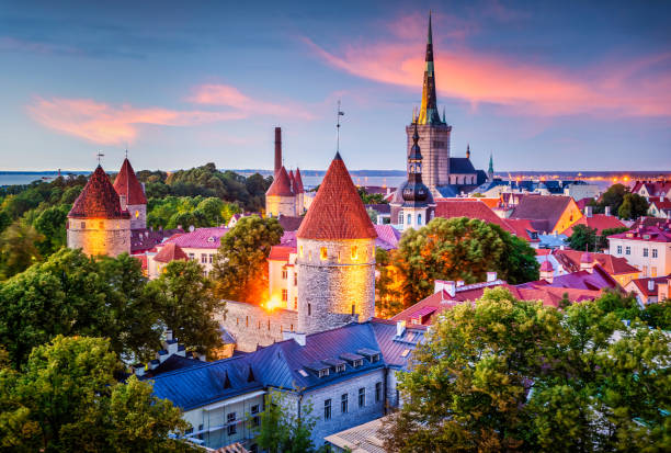 Tallinn Estonia Old City at dusk View of the Old City of Tallinn, Estonia, with City Wall Towers and St Olaf’s Church, as seen from Toompea at dusk town wall tallinn stock pictures, royalty-free photos & images