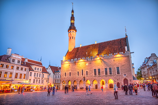 Tallinn, Estonia - August 5, 2019: Town Hall square in the Old Town of Tallinn at dusk, which is included in the UNESCO World Heritage.