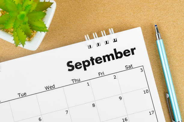 istock September 2022 desk calendar on brown background. 1402865851