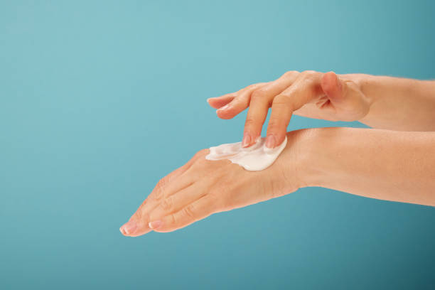 istock Crop female smearing cream on hand 1402866709