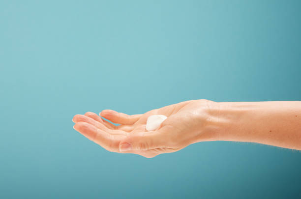 istock Crop female demonstrating soft cream 1402866730