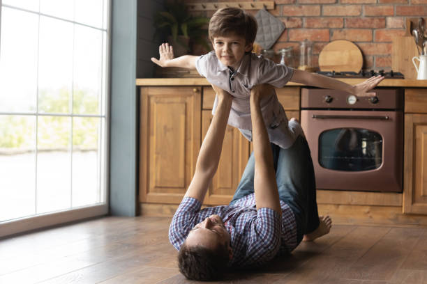 istock Happy young father carrying cute small kid son. 1402867199