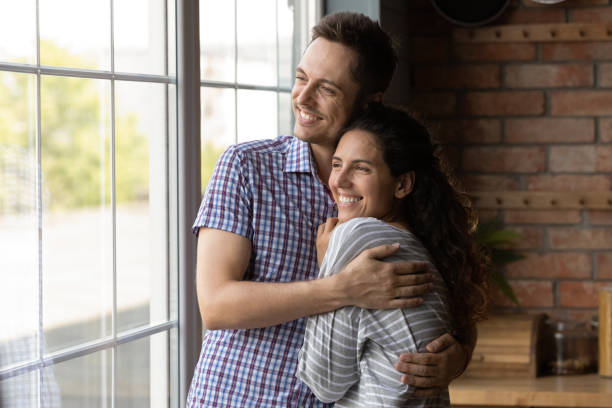 istock Dreamy loving young couple visualizing future together at home. 1402867230
