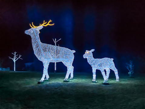 Glowing deer sculptures at Soho Square at night in Sharm El Sheikh, Egypt. Christmas holiday illumination outdoors in Egyptian town