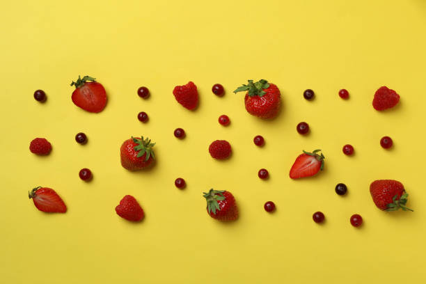 istock Delicious fresh berry mix on yellow background 1402871008