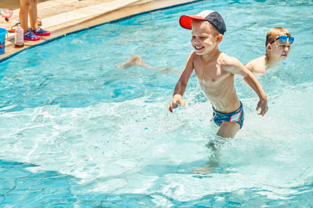 istock Cute brothers enjoy swimming in pool at hotel territory 1402871017