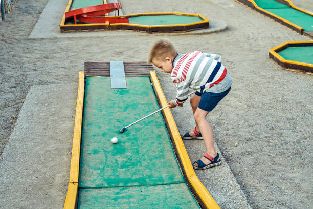 istock Boy plays mini golf on the territory of the hotel 1402872438