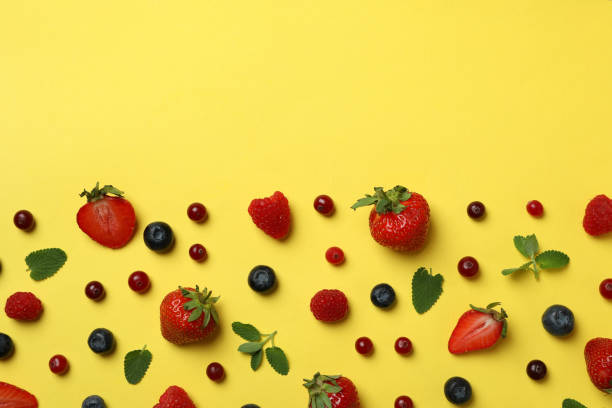 istock Delicious fresh berry mix on yellow background 1402872521