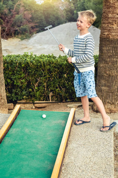 istock Boy plays mini golf on the territory of the hotel 1402872885