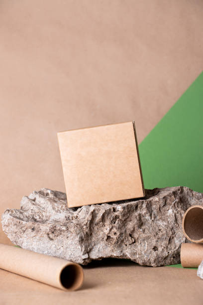 istock Brown cardboard box on a pastel background. Natural stones and art objects. 1402872975
