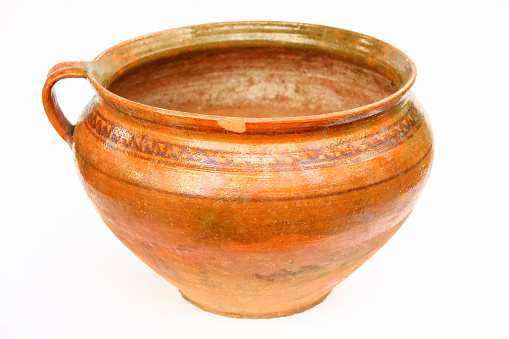 Vintage clay brown pot. Old traditional pottery. Ancient clay pot of Ukrainian culture.