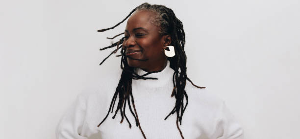 istock Happy mature woman whipping her dreadlocks in a studio 1402873397
