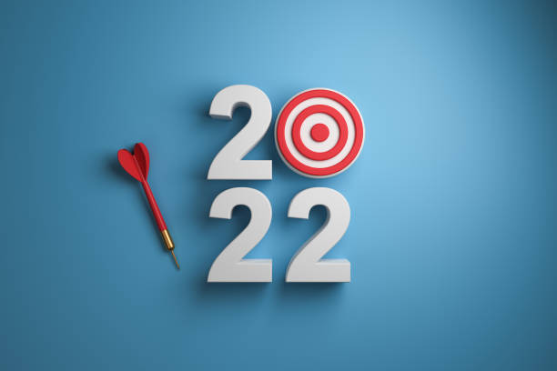 istock 3D volumetric 2022 with target and dart on blue background top view. 1402874070