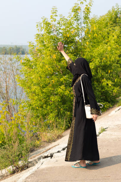 istock A Muslim woman meets an approaching boat with her relatives 1402874282