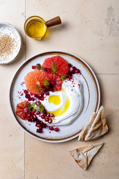istock Labneh middle eastern lebanese cream cheese dip. Labneh with grapefruit,  roasted beetroot, pomegranate, fennel, sumac. 1402875653