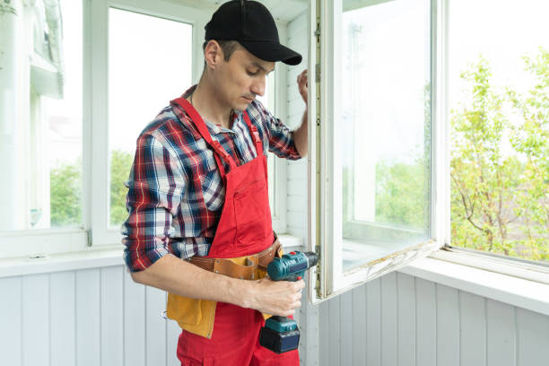 istock handyman adjusting white pvc plastic window indoors. worker using screwdriver to repair upvc window. homework maintenance 1402875754