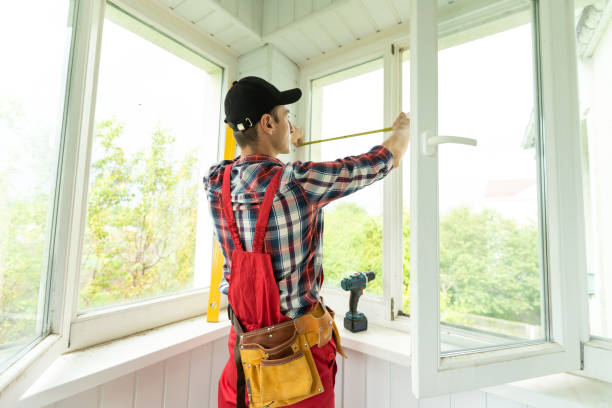 Man measuring window prior to installation of roller shutter outdoors. stock photo