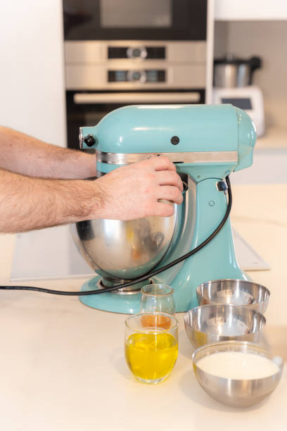 istock A man baker cooking a red velvet cake at home, preparing the cake in the kitchen robot, work at home 1402876754