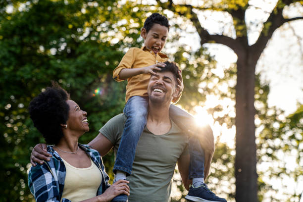 istock Young loving family having fun in the park 1402877782