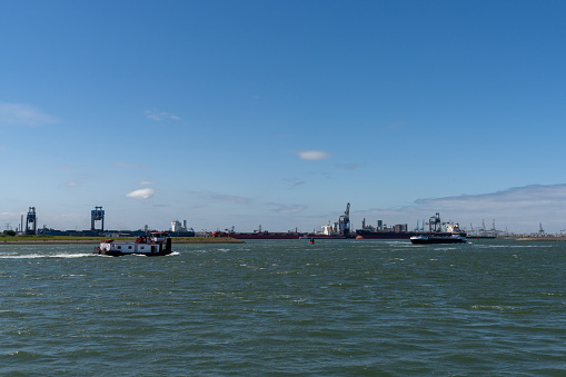 Hoek van Holland, Netherlands - 10 June, 2022: river barges in the Rhine estuary near Rotterdam carrying freight inland
