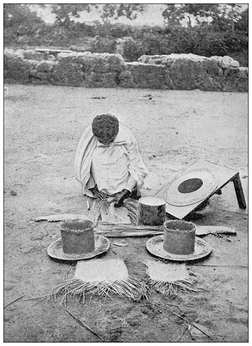 Antique photo: Madagascar, woman braiding hat