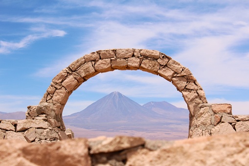 Arch at Pukara de Quitor near San Pedro de Atacama and Licancabur volcano on the background, Chile.