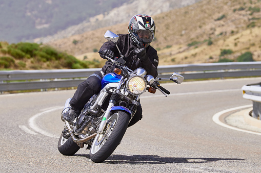 motorcyclist at high speed circulating through the port of navalmoral, in the province of Avila, Spain, during the month of August 2021