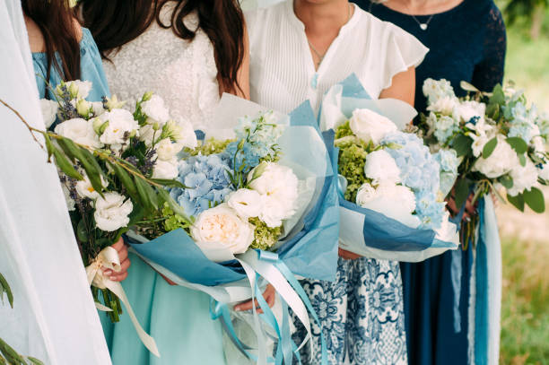 istock Bridesmaids with bouquets closeup. Blue wedding. Guests lesbians 1402890369