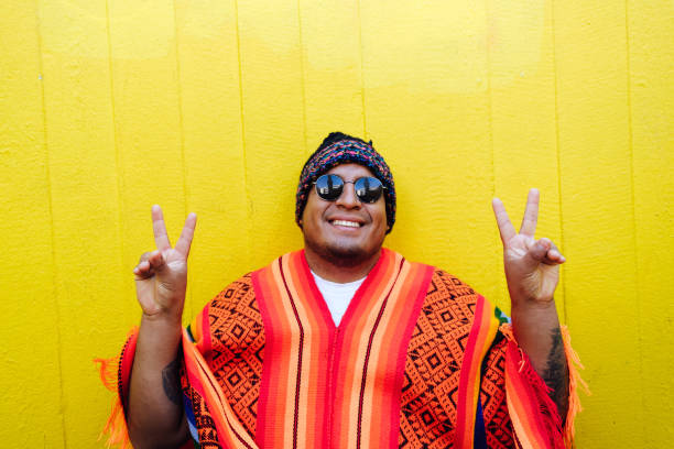 istock Joyful south american guy showing peace sign 1402890645