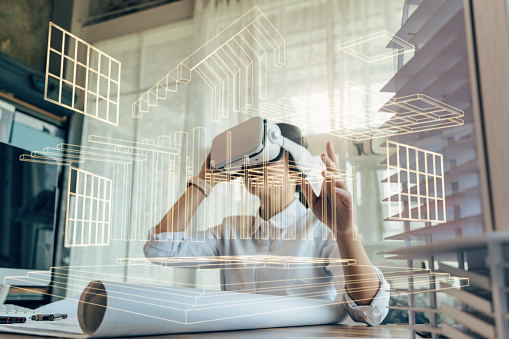 Mujer asiática Arquitecta o Ingeniera con auriculares VR para trabajar diseño arquitectónico 3D modelo de edificio prefabricado de hormigón con tecnología BIM y tecnología de realidad virtual. photo