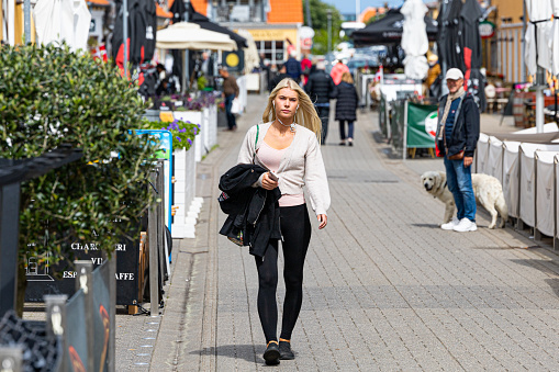 Skagen, Denmark June 7, 2022 A blonde woman walking down the main street.