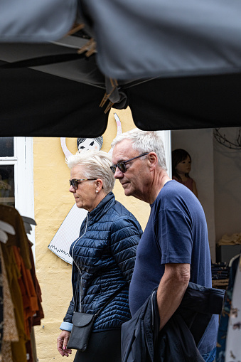 Skagen, Denmark June 7, 2022 An older couple walking on the main shopping street.