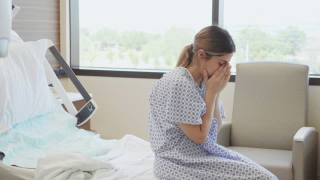 Young woman cries after miscarriage