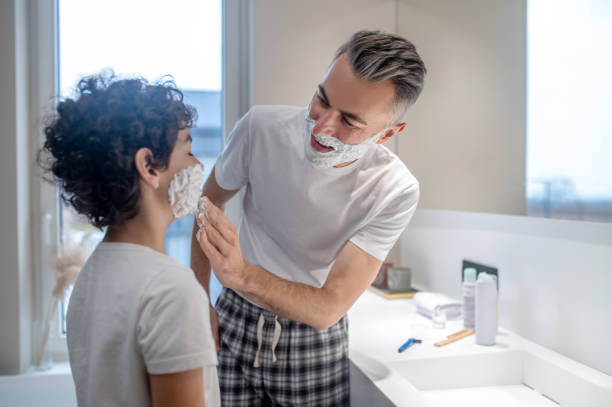 istock Dad teaching his little son how to shave 1402893187