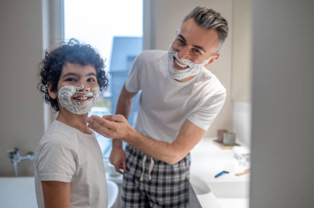 istock Dad teaching his little son how to shave 1402893203