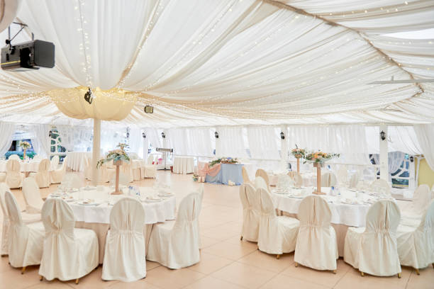 istock Table setting with blank guest card, plates with napkins and cutlery, copy space. Place setting at wedding reception. Round table served for banquet in restaurant 1402895160