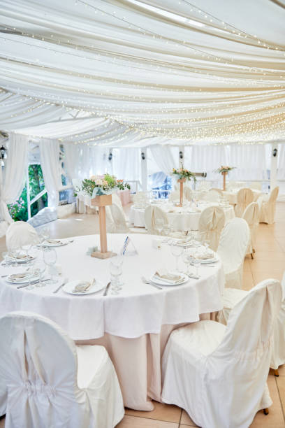 istock Table setting with blank guest card, plates with napkins and cutlery, copy space. Place setting at wedding reception. Round table served for banquet in restaurant 1402895163