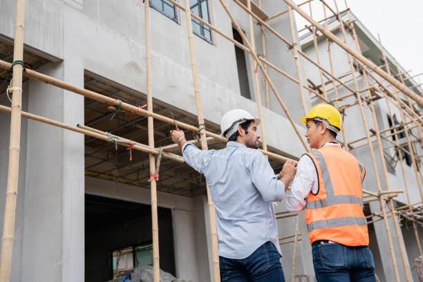istock The engineer manager and foremen discussed and pointed to the site projects on the construction site to check the various functions. 1402896312