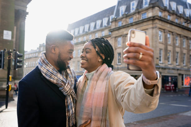 istock Cheerful Couple Taking Selfie With Mobile Phone 1402896315