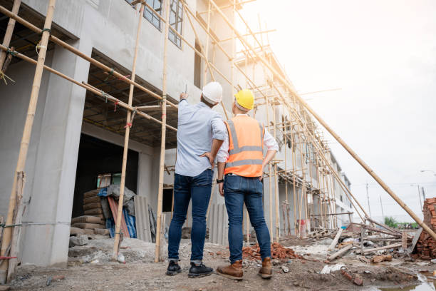 istock The engineer manager and foremen discussed and pointed to the site projects on the construction site to check the various functions. 1402896472