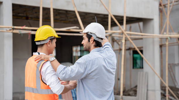 istock The engineer manager and foremen discussed and pointed to the site projects on the construction site to check the various functions. 1402896508