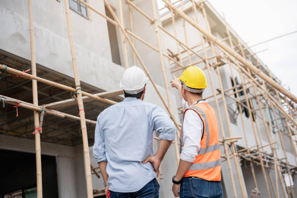 istock The engineer manager and foremen discussed and pointed to the site projects on the construction site to check the various functions. 1402896567