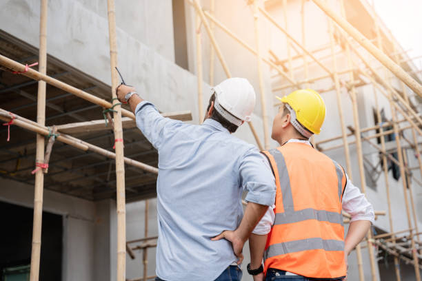 istock The engineer manager and foremen discussed and pointed to the site projects on the construction site to check the various functions. 1402896623