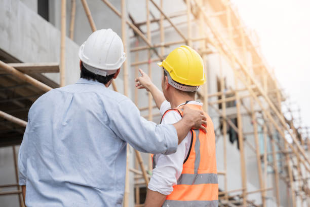 istock The engineer manager and foremen discussed and pointed to the site projects on the construction site to check the various functions. 1402896732