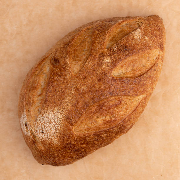 istock fresh homemade bread on parchment background, top view 1402897463